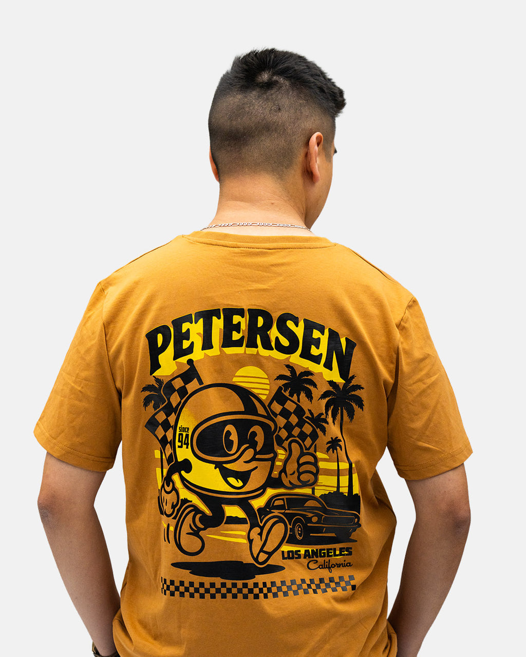 Petersen Tee- Driving Mascot Ochre