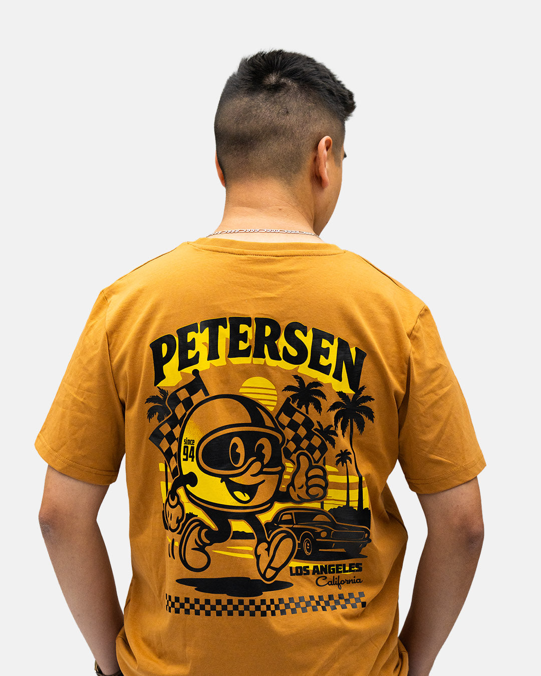 Petersen Tee- Driving Mascot Ochre