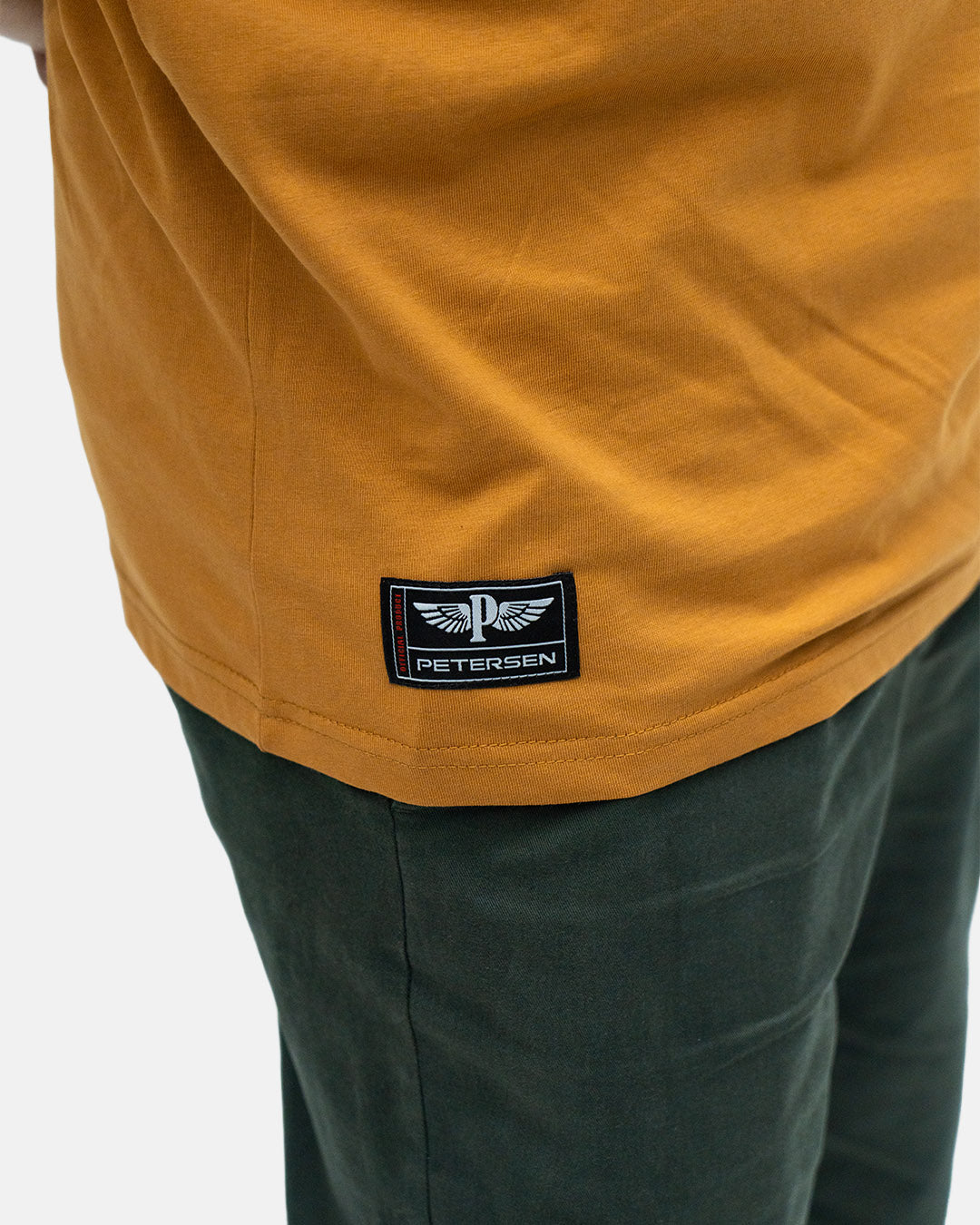 Petersen Tee- Driving Mascot Ochre
